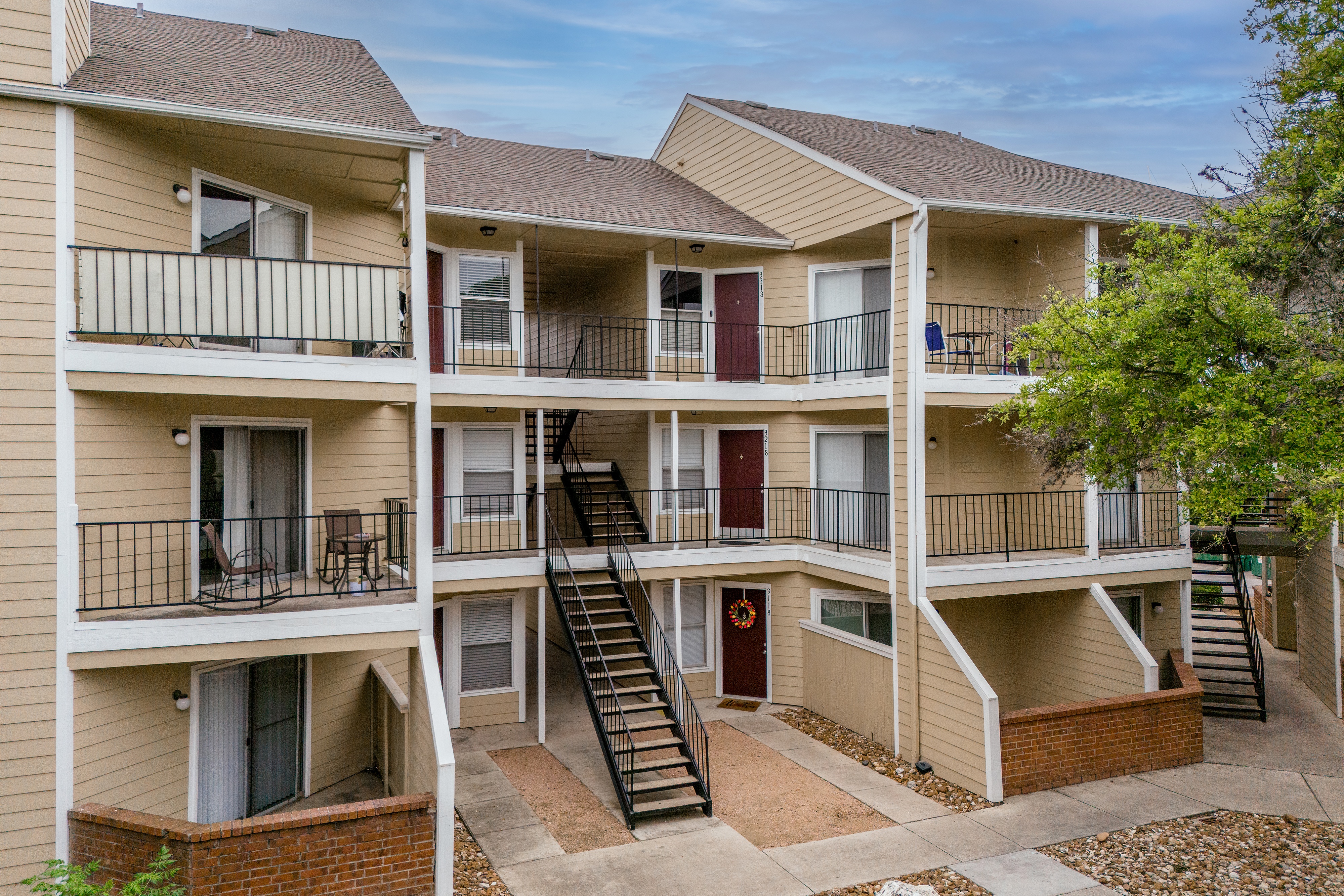 Apartment complex with multiple balconies and staircases.